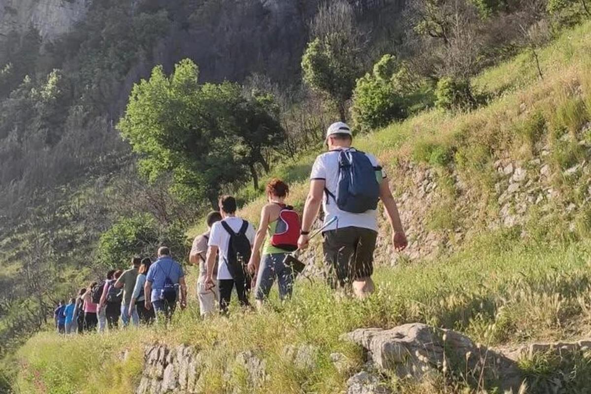 a group of people walking up a hill