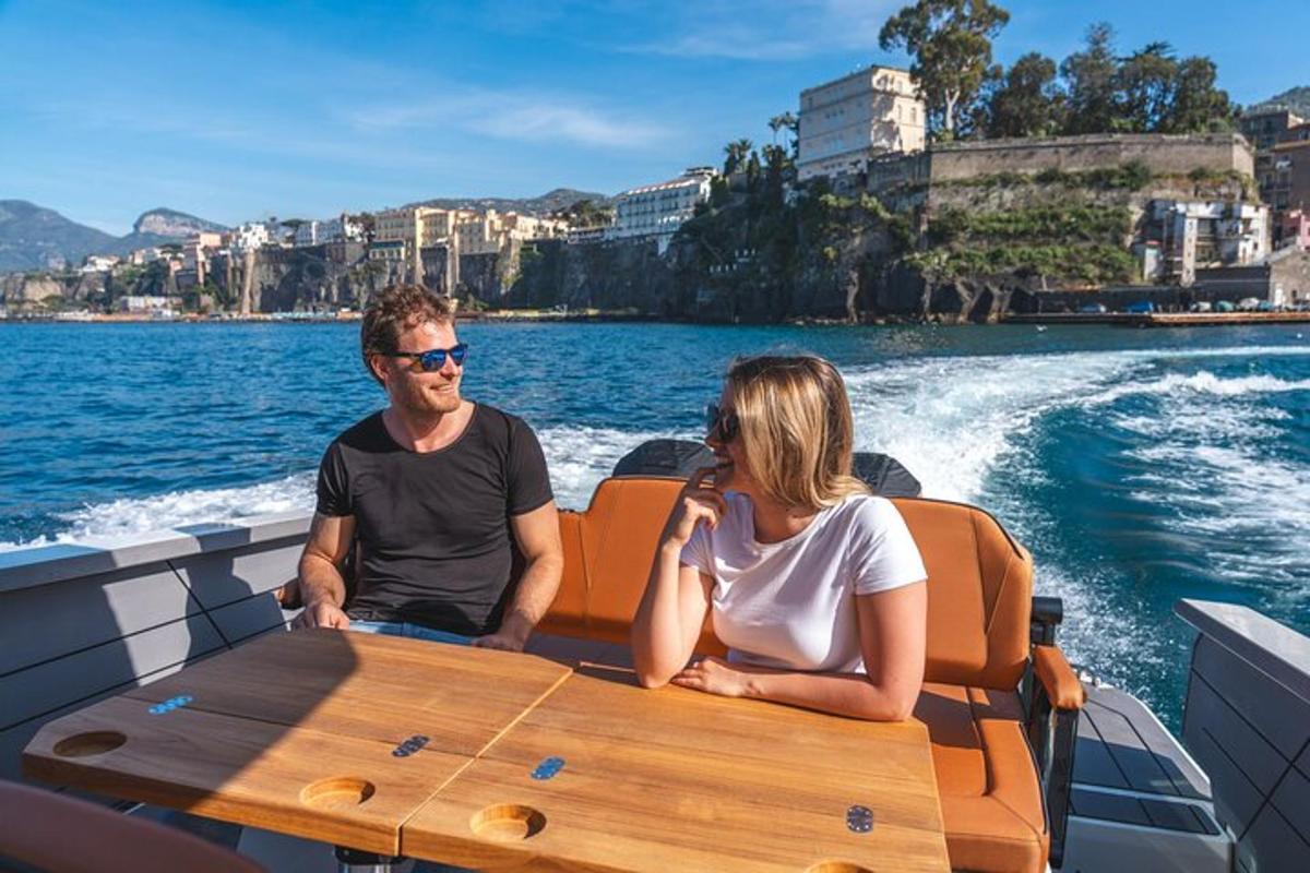 a man and woman sitting at a table on a boat