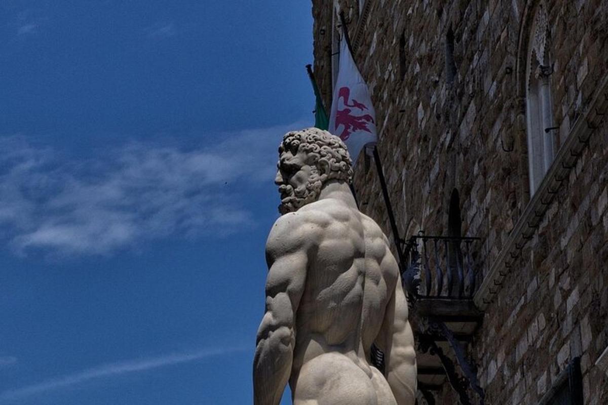 a statue of a man standing next to a building
