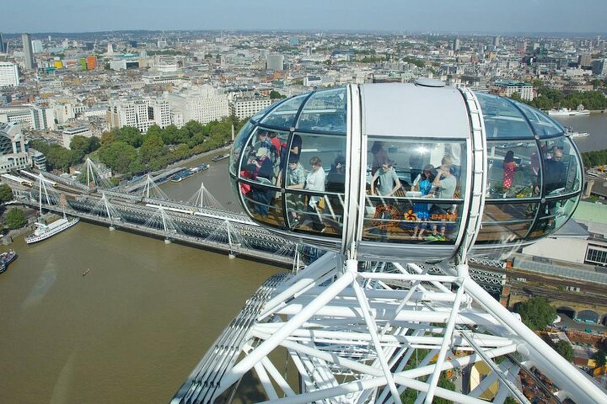 a group of people on a ferris wheel over a river