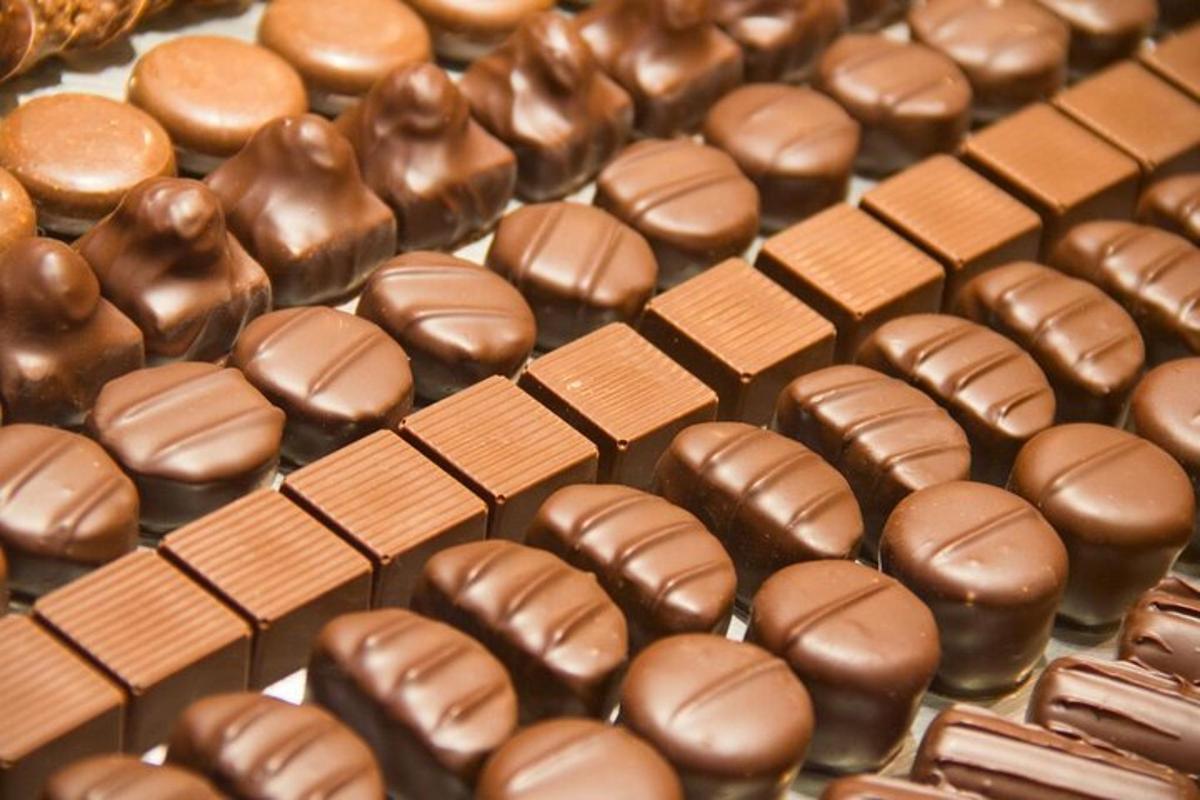 a bunch of chocolate covered donuts on a table