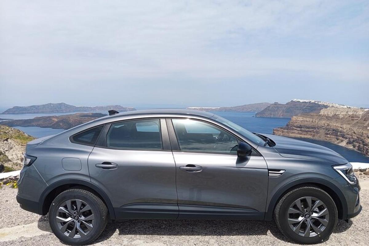 a silver car parked on the side of a cliff