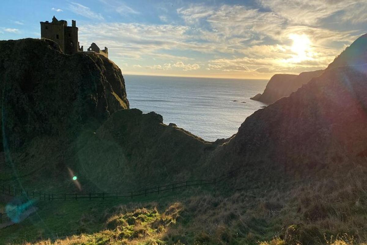 a castle on a cliff next to the ocean