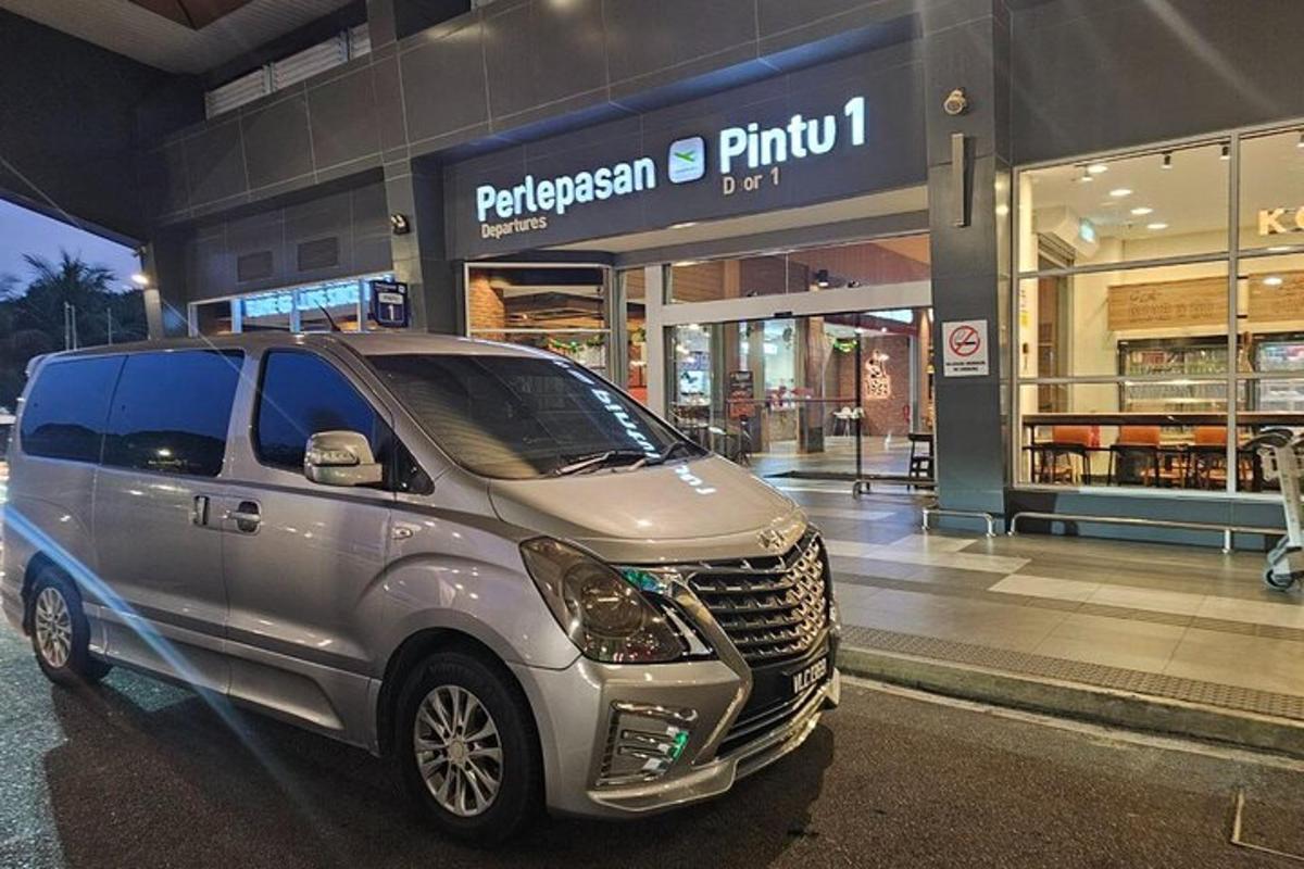 uma van prateada estacionada em frente a uma loja