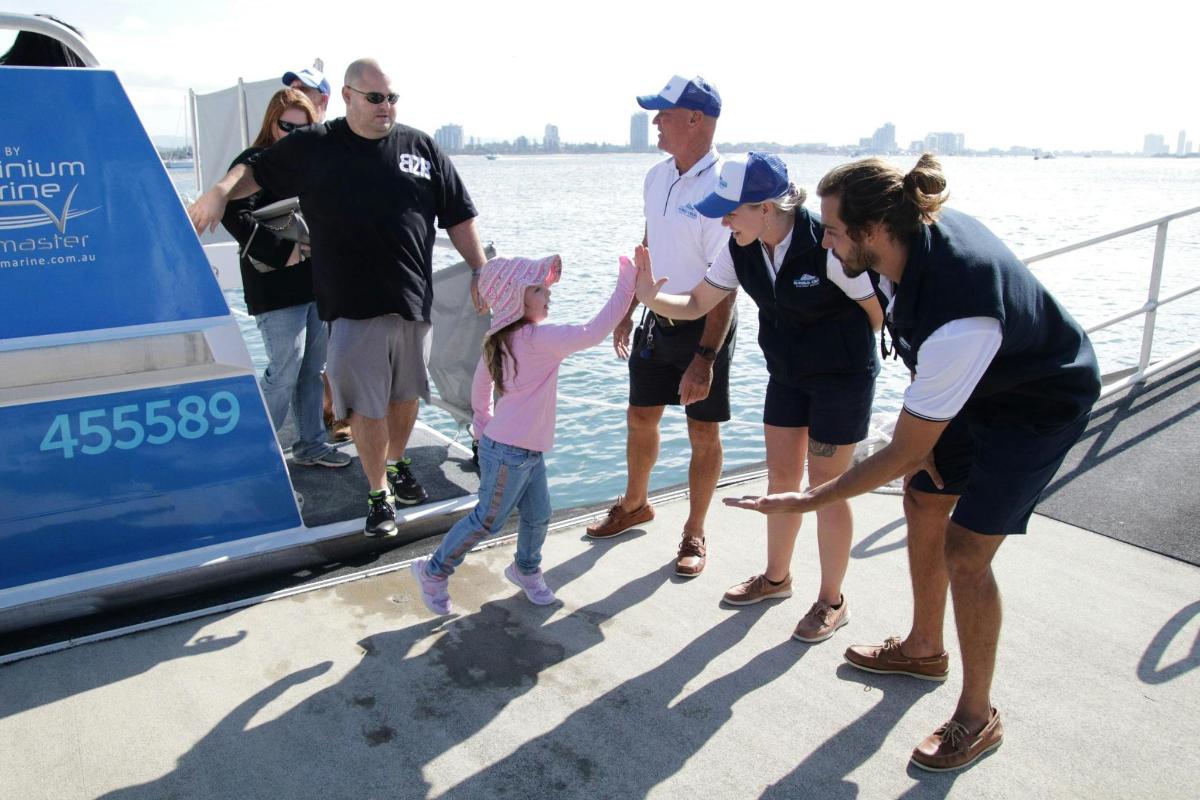 a group of people standing on a boat
