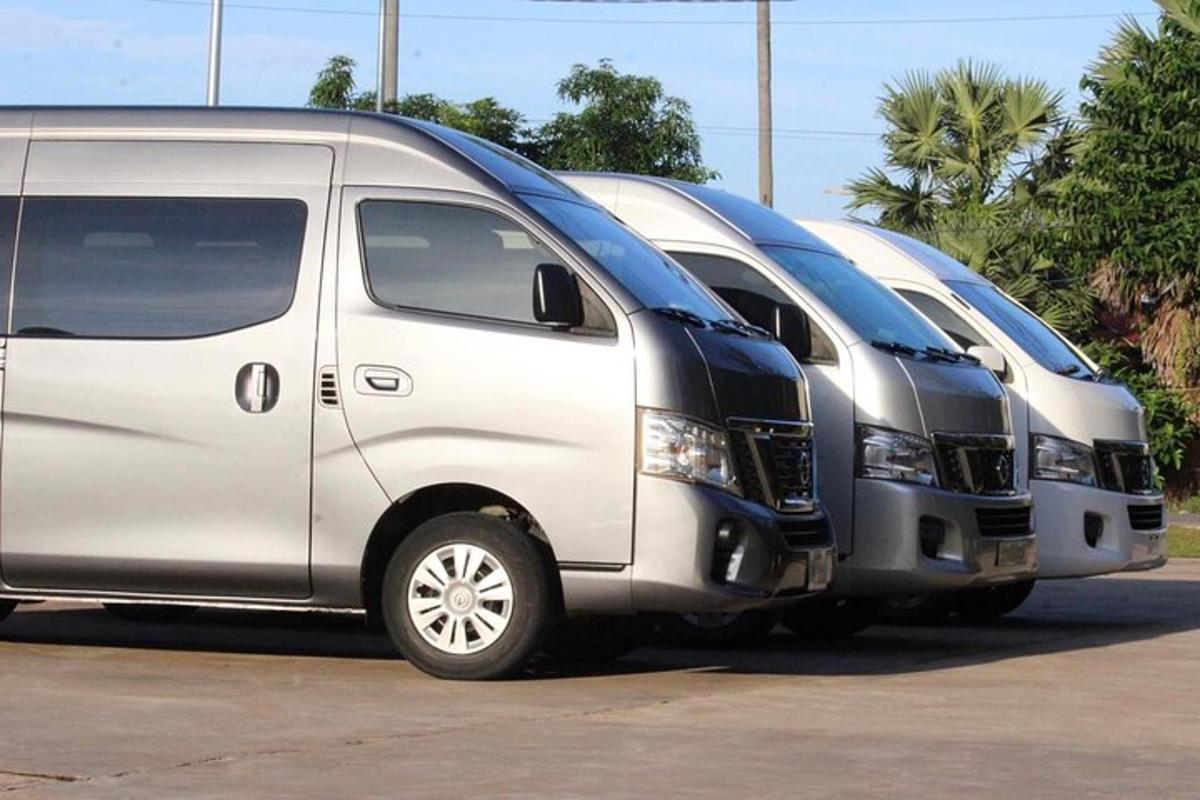 two silver vans parked next to each other