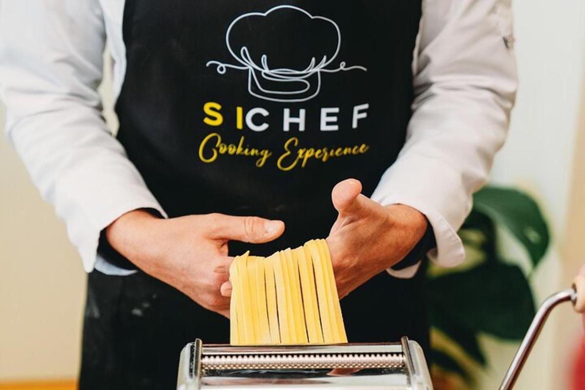 a man wearing apron holding a box of pasta