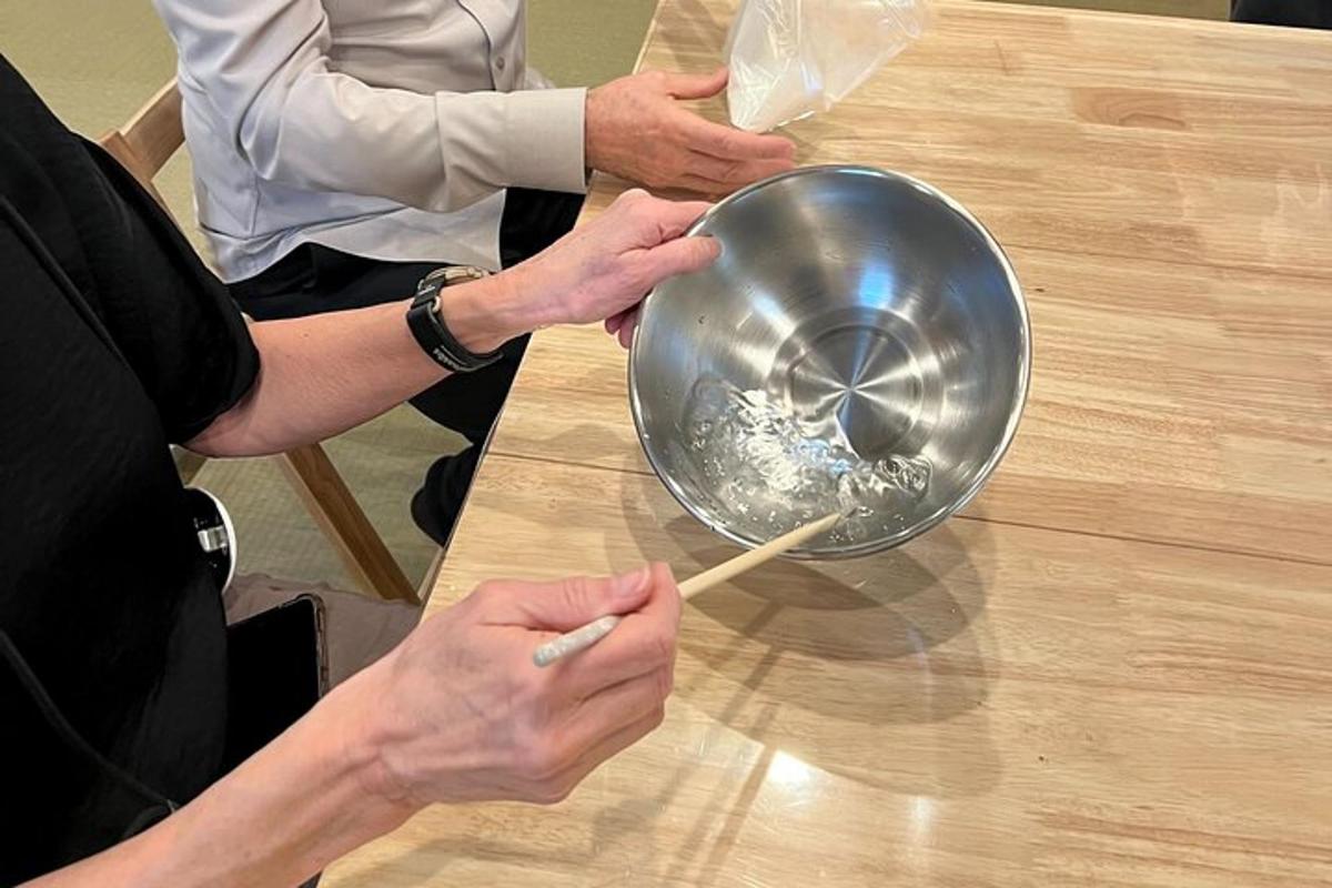 a person holding a bowl on top of a table
