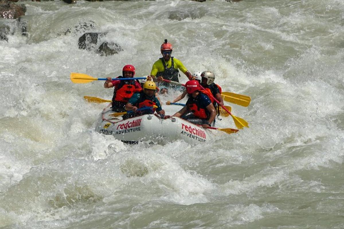 a group of people in a raft in the water