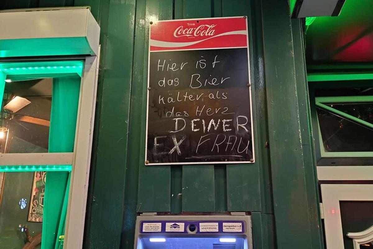 a cocacola sign on a wall next to a vending machine