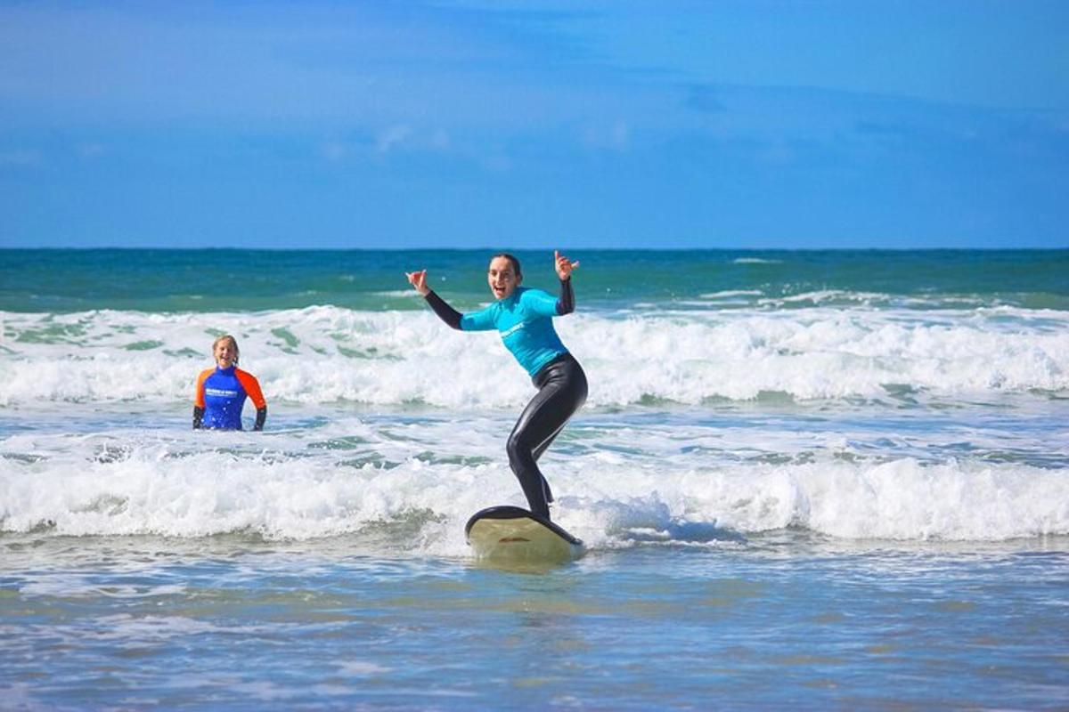 a woman is standing on a surfboard in the ocean