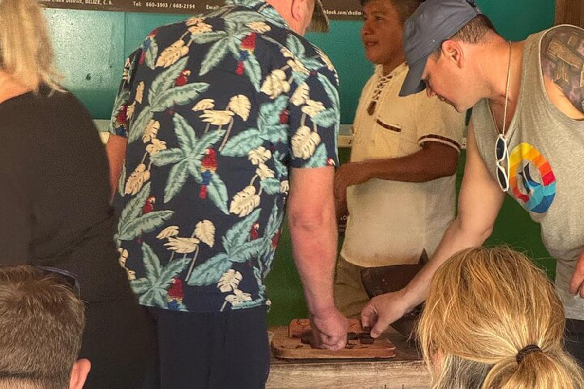 a man in a hawaiian shirt looking at a cutting board