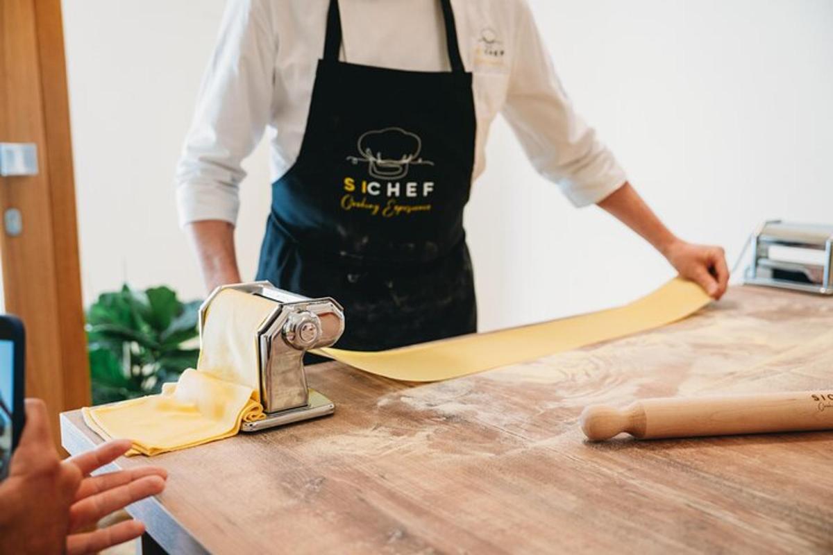 a man in an apron is cutting a surfboard on a table