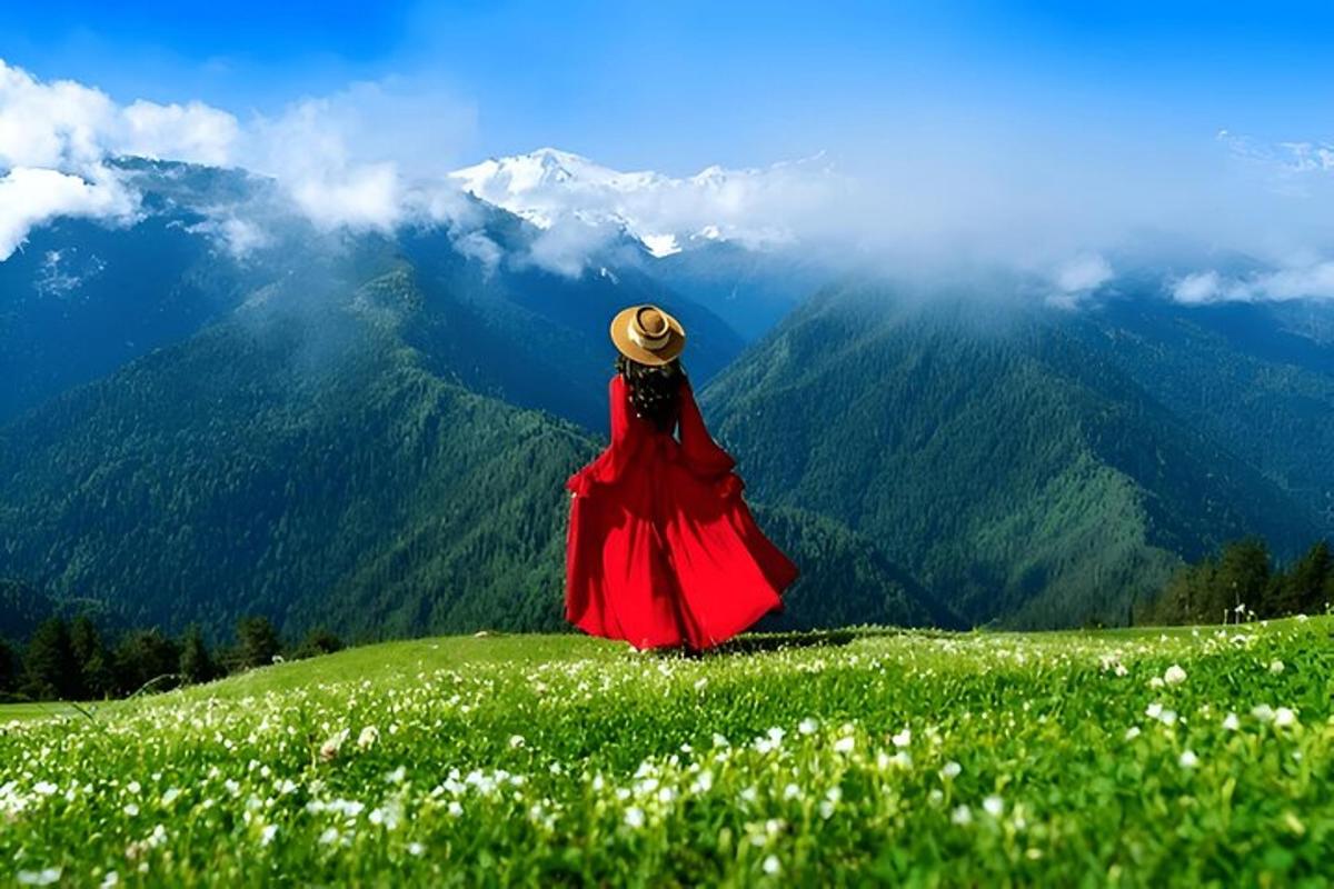 a woman in a red dress sitting on a grassy hill