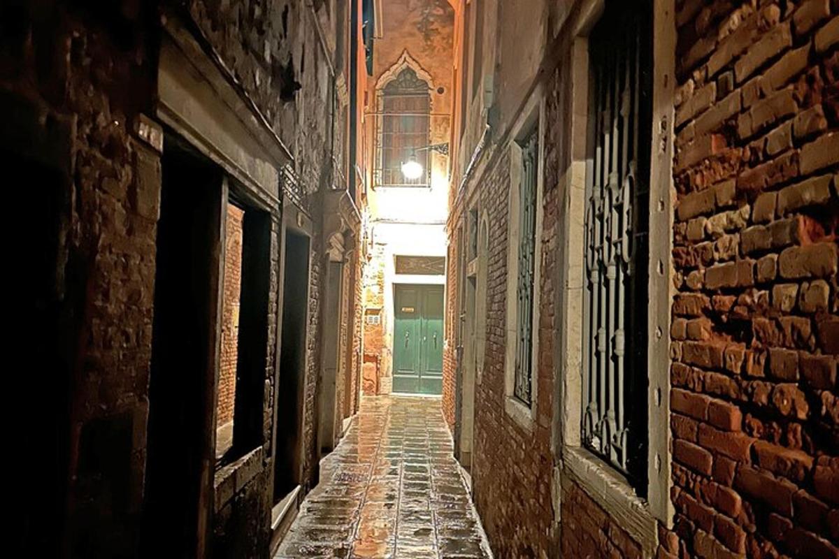 un vicolo con un muro di mattoni e una finestra