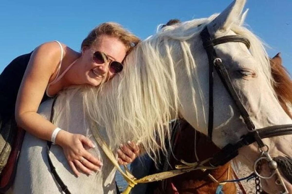 a woman riding on the back of a horse
