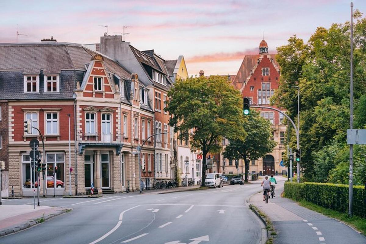 a person riding a bike down a street with buildings