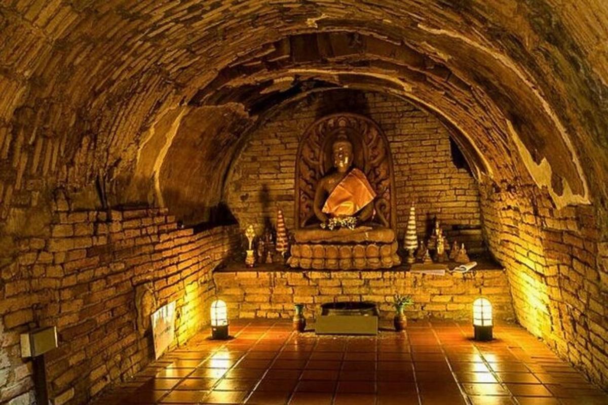 a room with a statue in a brick wall