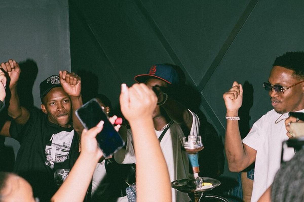 a group of people with their hands up in a crowd