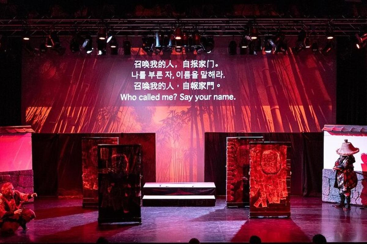 a stage with red curtains and a person on the stage