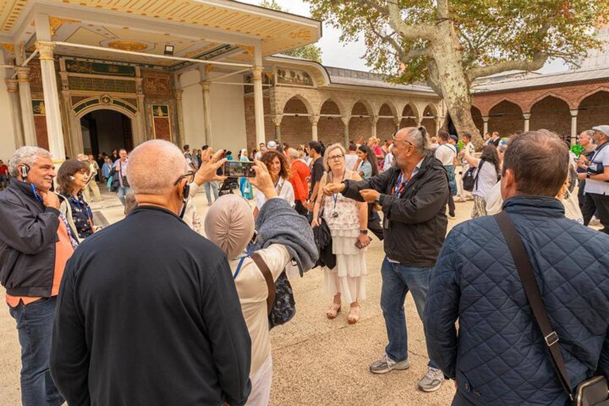 a crowd of people standing outside a building with a camera