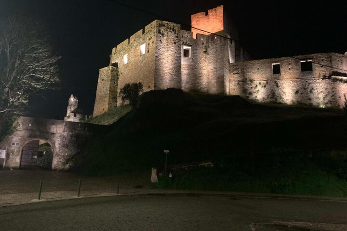 hrad stojící v noci na vrcholu kopce