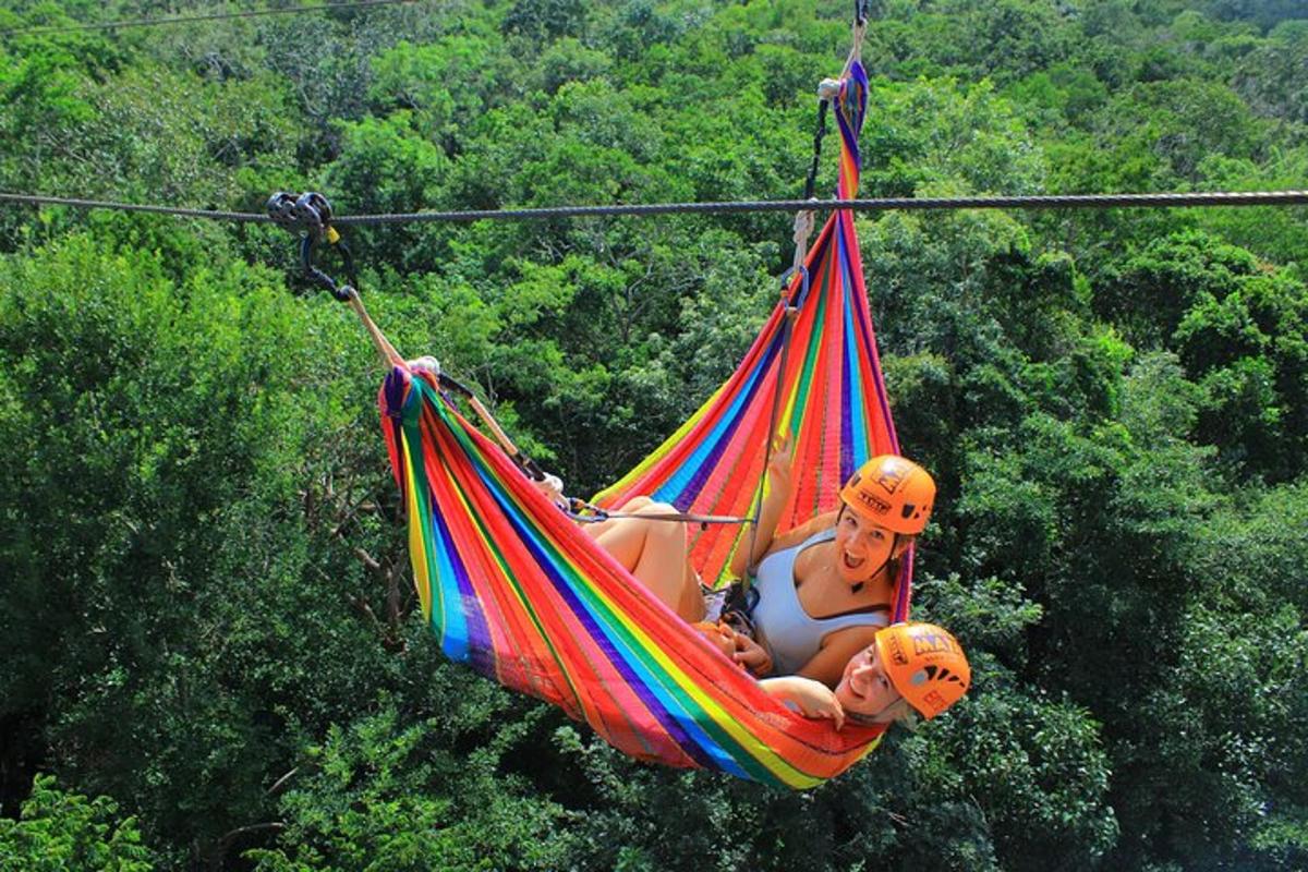 two people are sitting in a hammock
