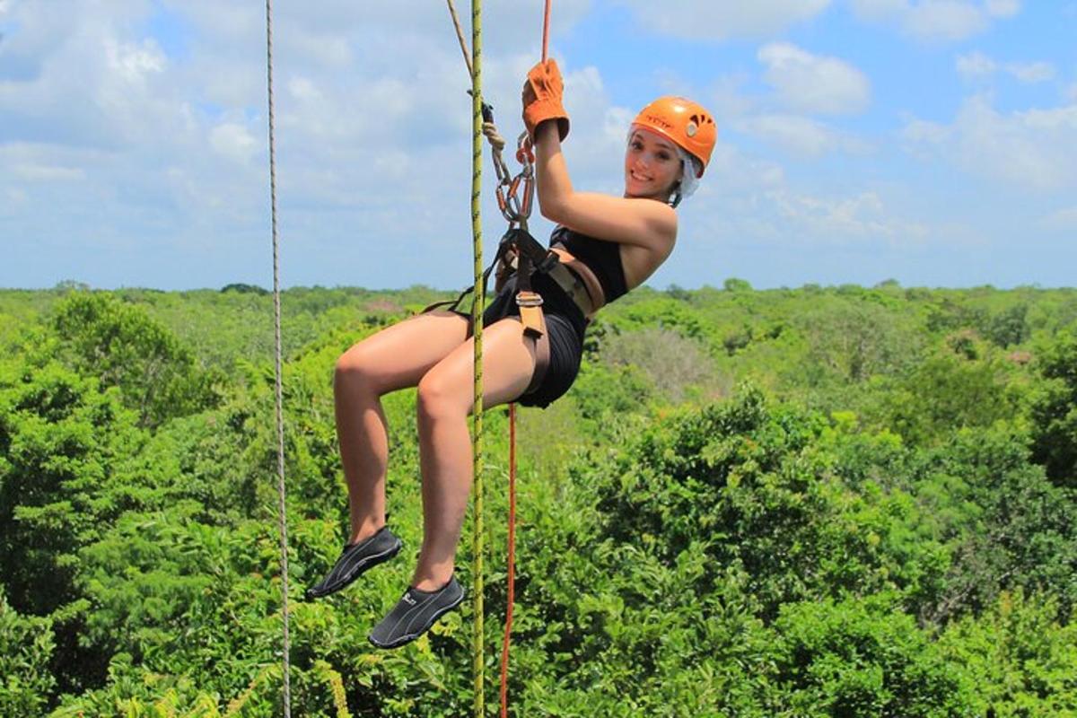 a woman on a zip line in the jungle