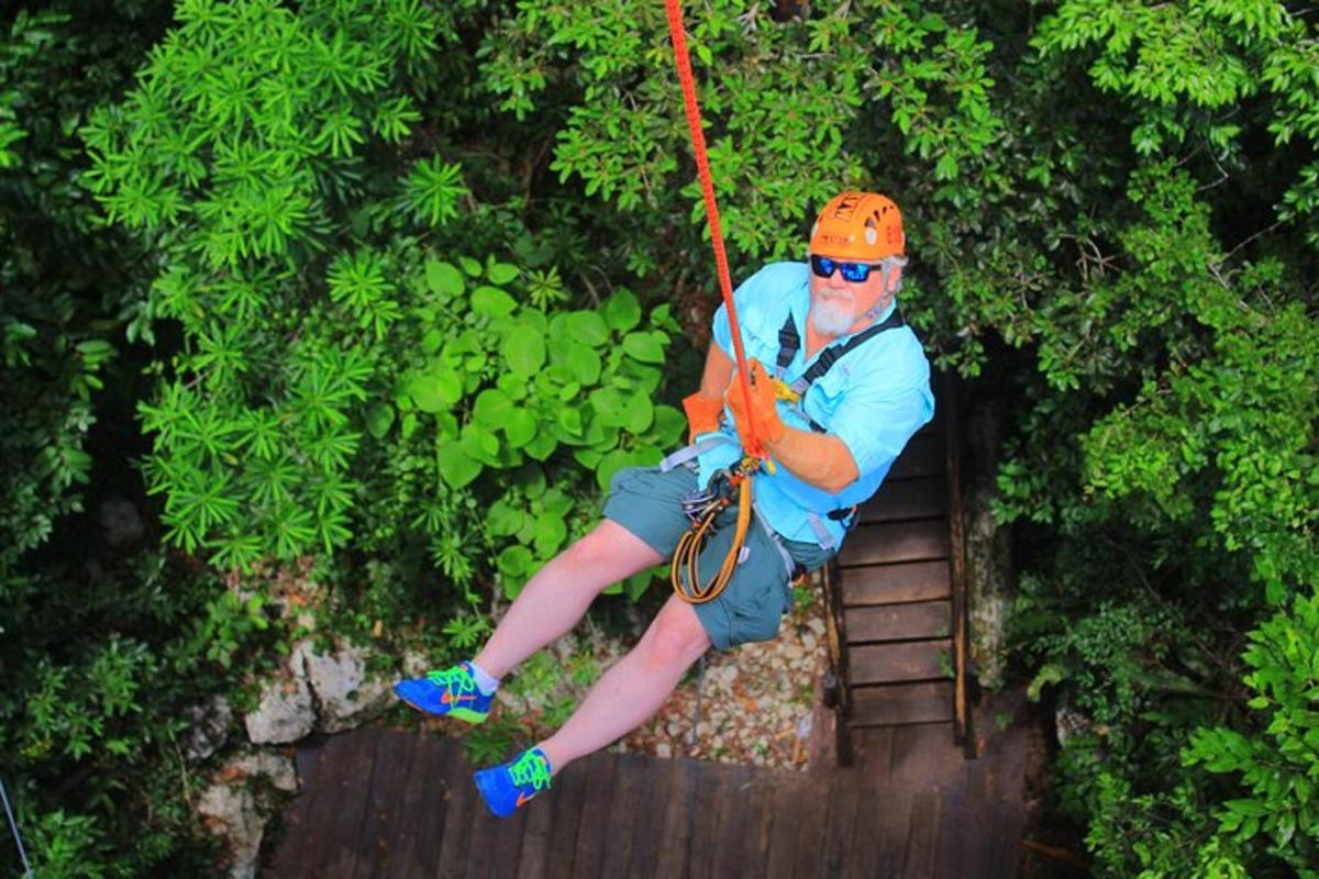 a man on a rope swing in the jungle