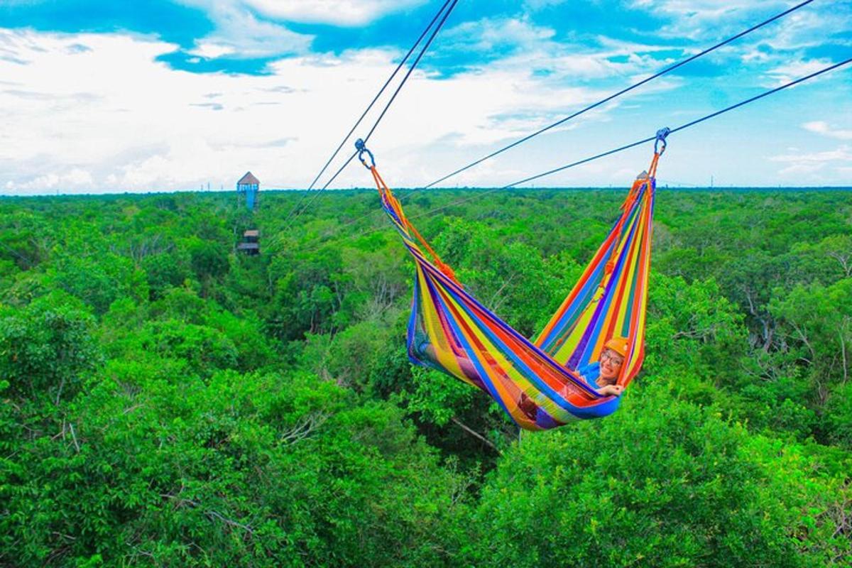 a colorful hammock hanging over a lush green forest