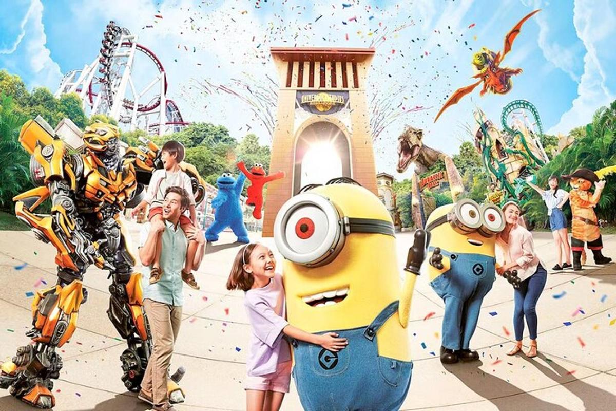 a group of children standing in front of a amusement park