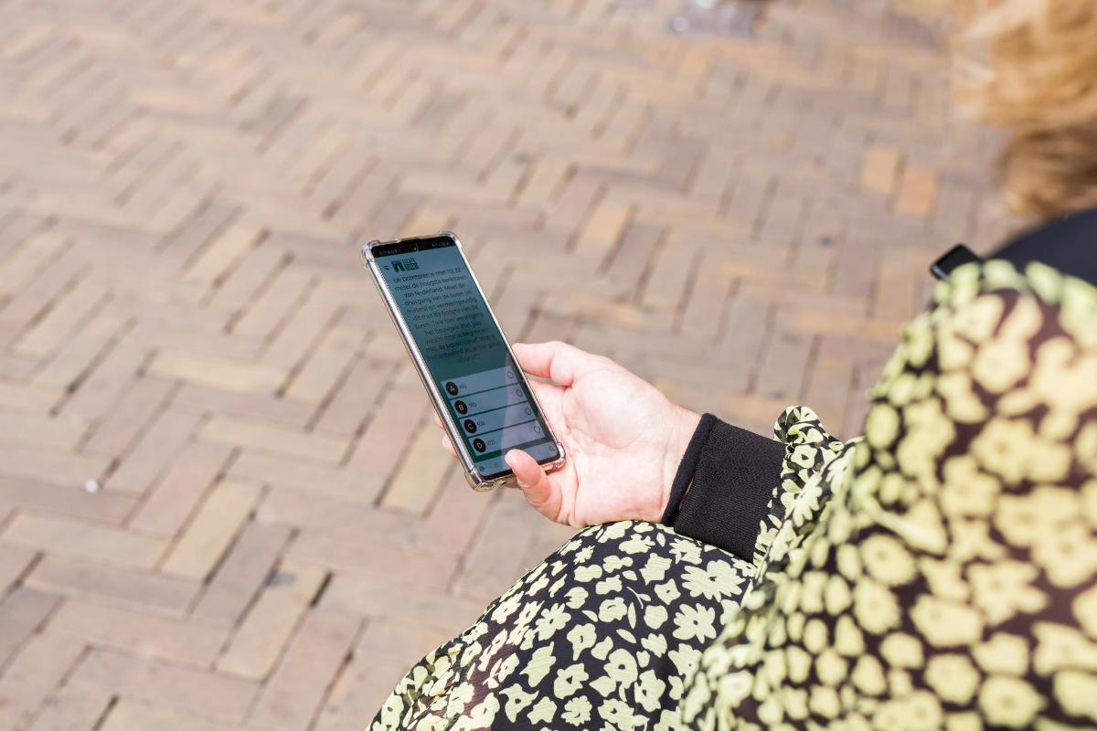 una mujer sosteniendo un teléfono celular en su mano