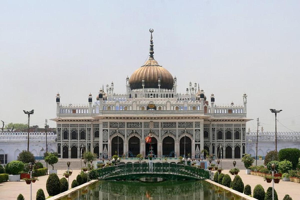 a large building with a pond in front of it