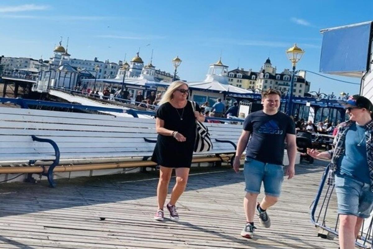 grupp inimesi, kes kõnnivad kai ääres