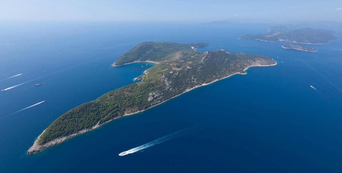an island in the water with a boat in it