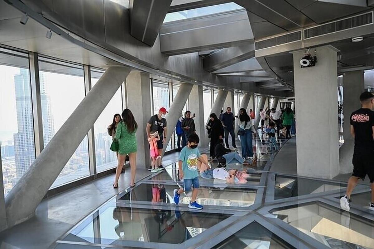 a group of people on the glass floor of a building