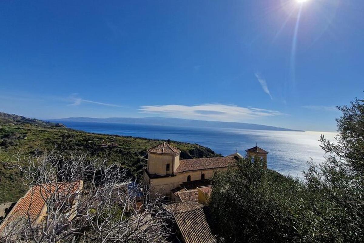 o casă pe un deal cu oceanul în fundal