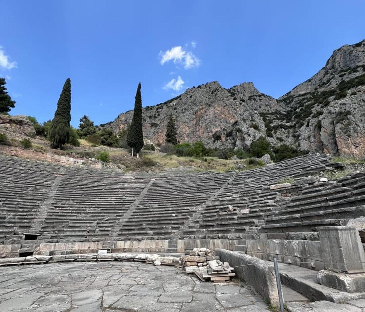 an empty amphitheater with a mountain in the background