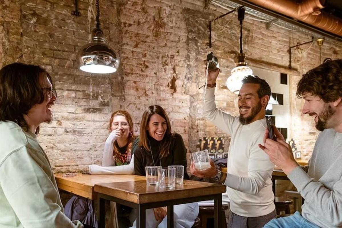 a group of people sitting around a table in a bar