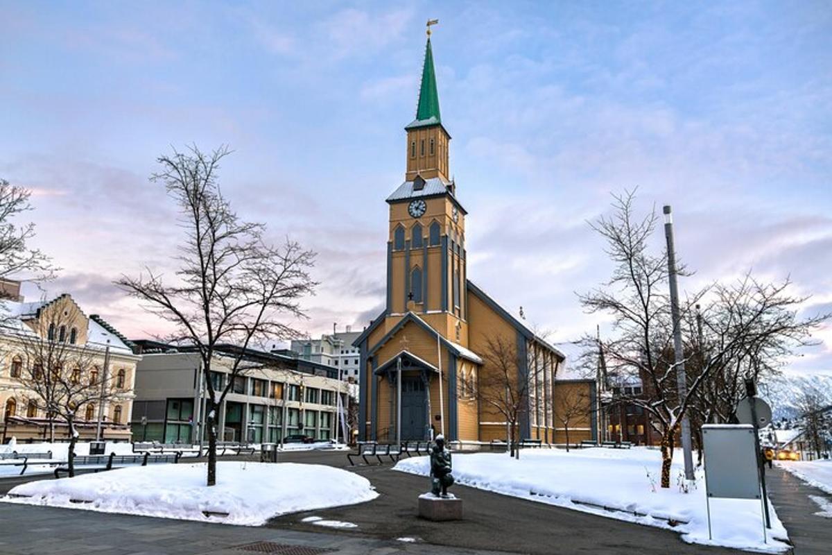 a church with a clock tower in the snow