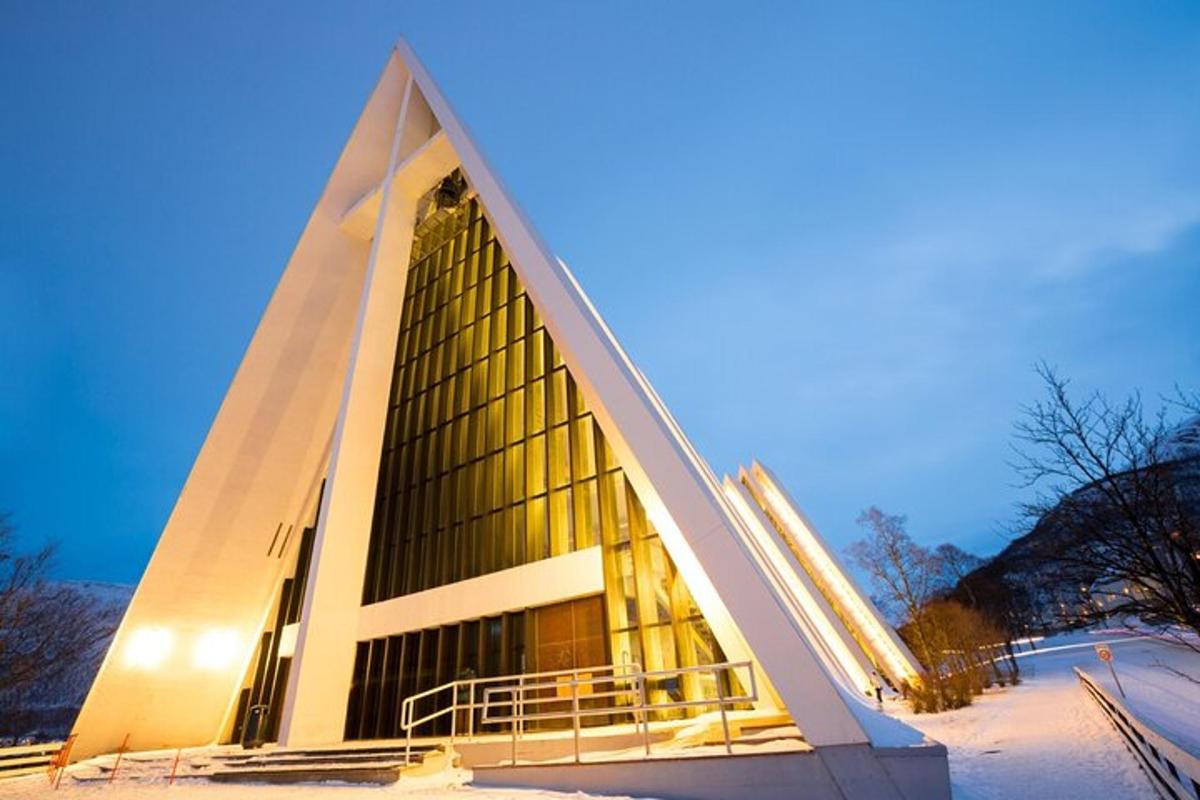 a pyramid shaped building in the snow at night