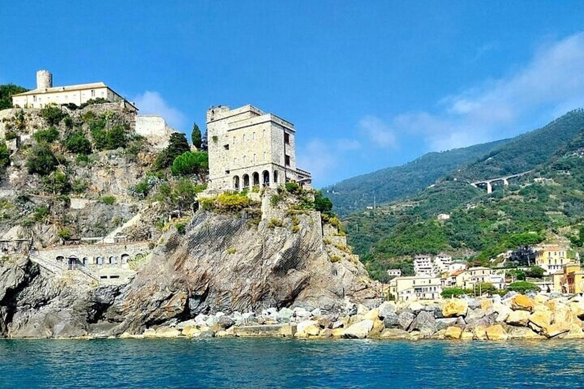 a building on top of a mountain on the water
