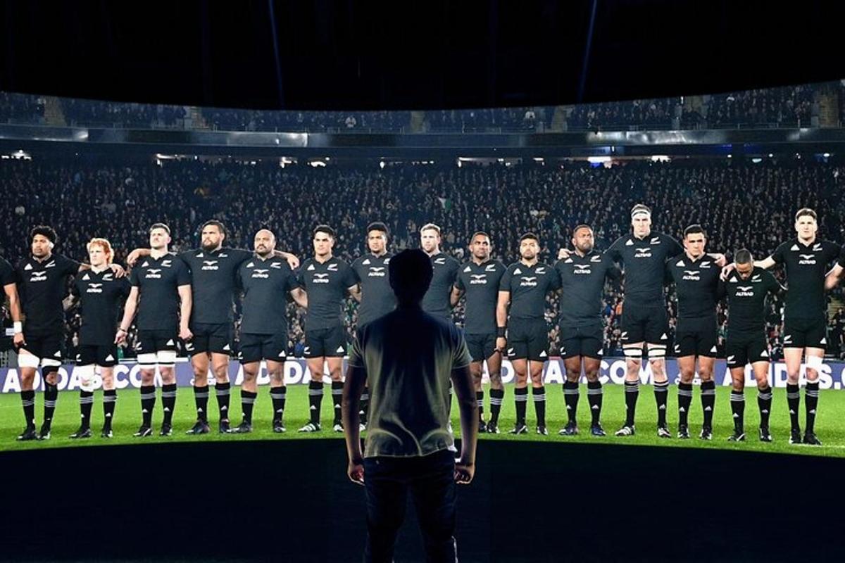 a man standing in front of a soccer team on a field
