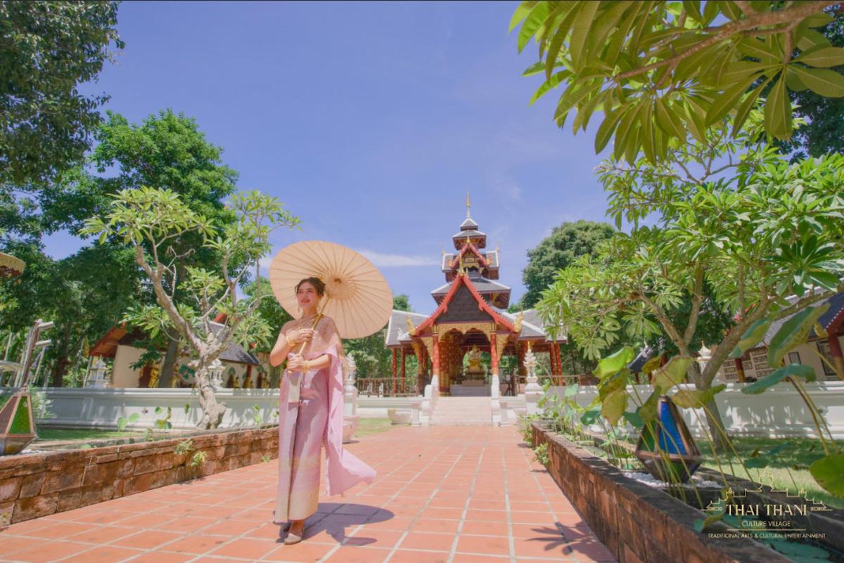 a woman holding an umbrella in front of a building