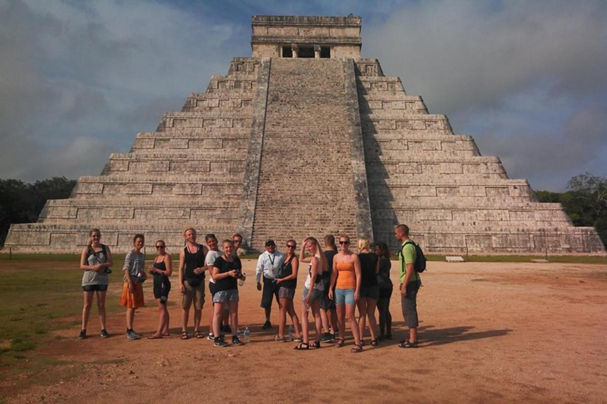 a group of people standing in front of a pyramid