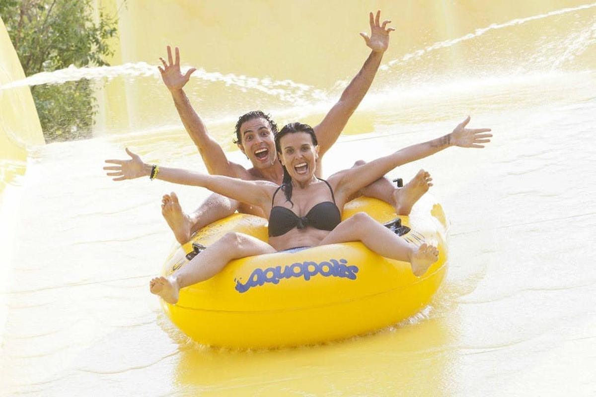 two people riding on a raft in the water