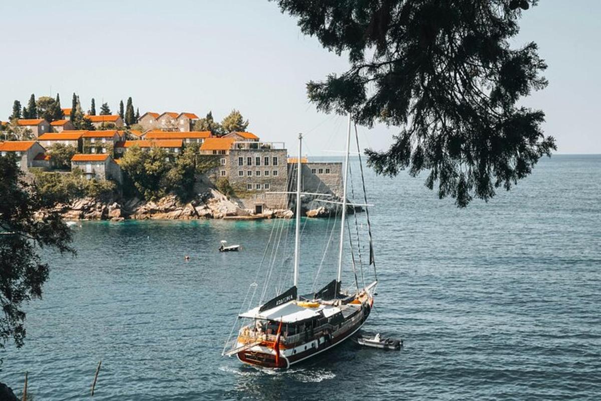 a sailboat in the water in front of a city