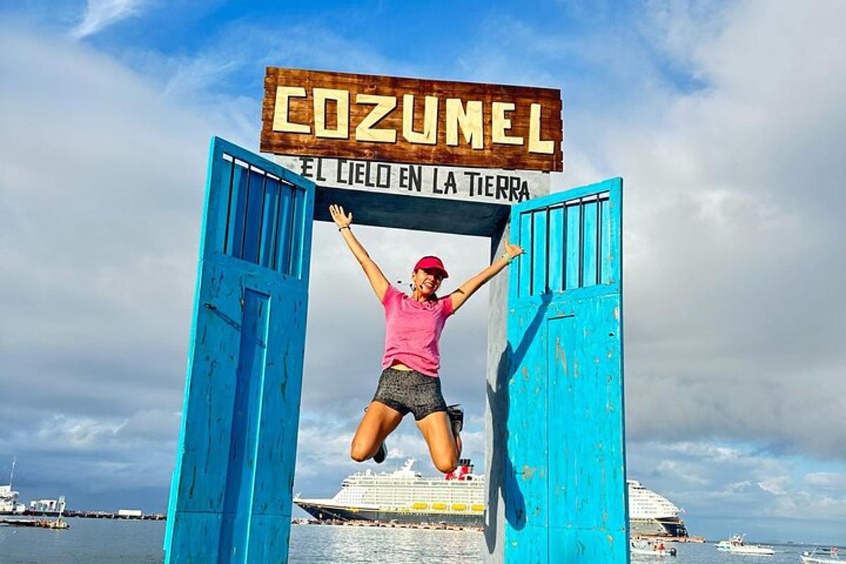 a woman jumping in the air in front of a sign