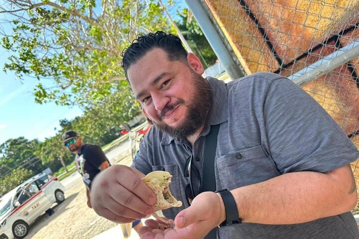 a man holding a piece of food in his hand