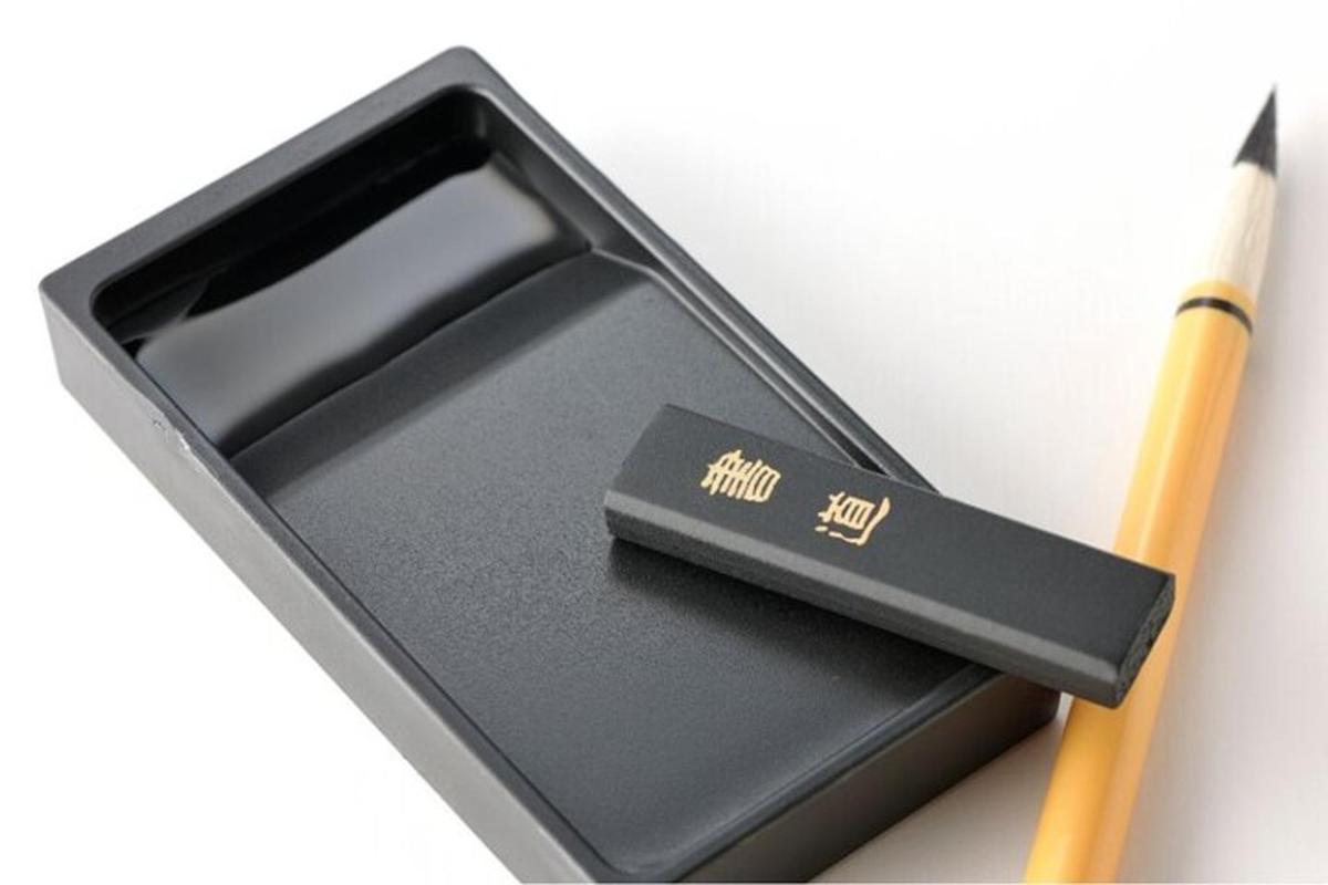 a pencil sitting next to a black box with a knife